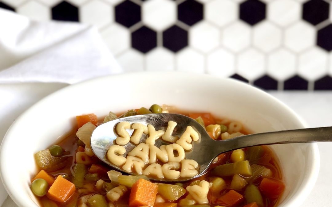 Bowl of homemade healthy alphabet vegetable soup with spoonful of noodles