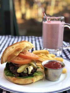 Homemade cheeseburger fries and pink mikshake