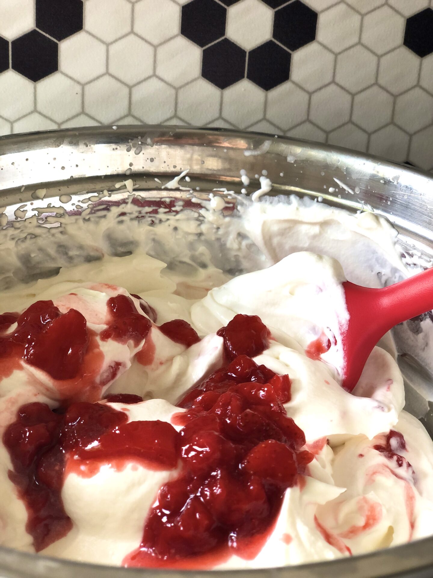 Strawberries and cream in a mixing bowl