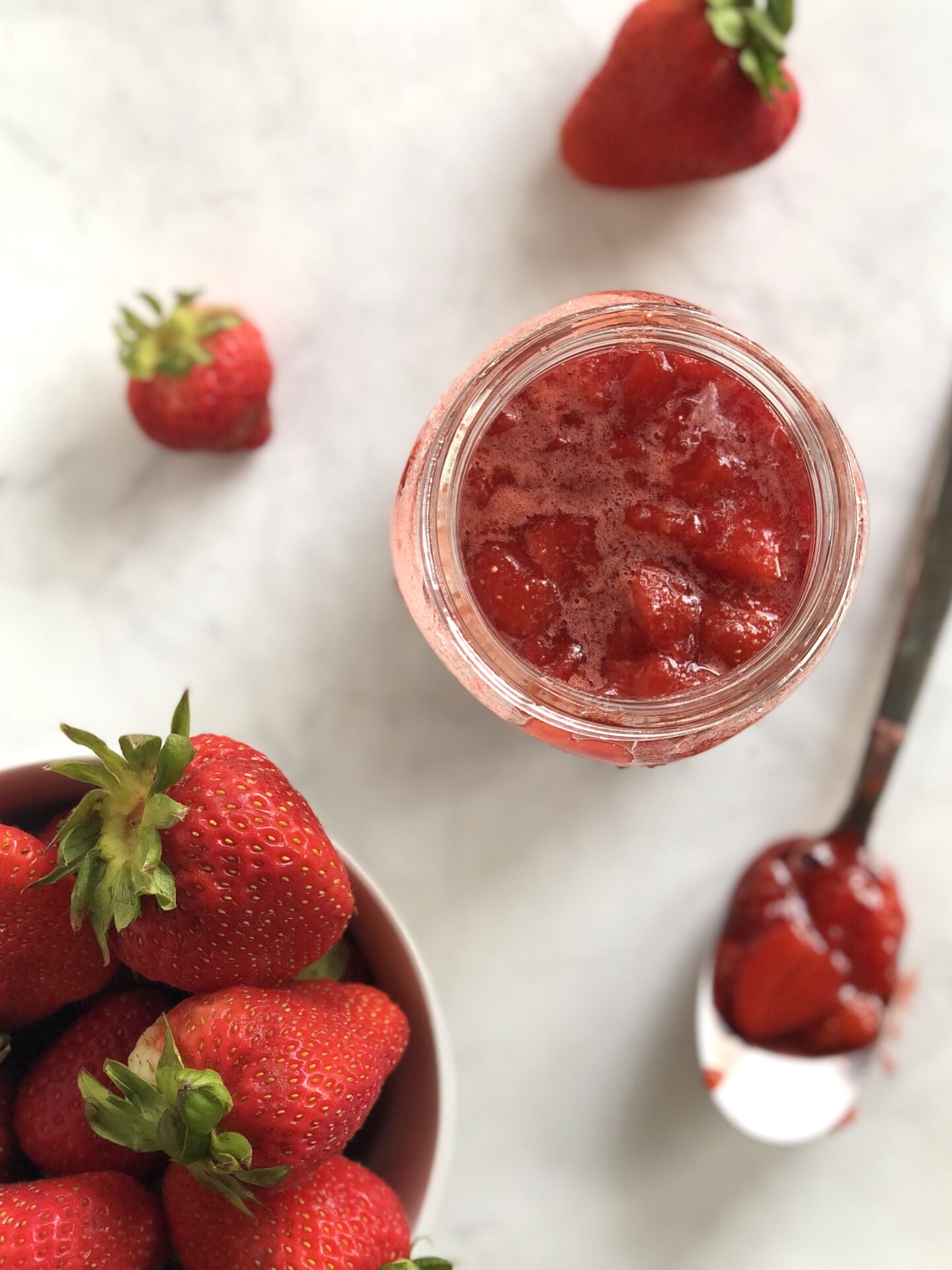 Strawberry sauce with fresh strawberries seen from above