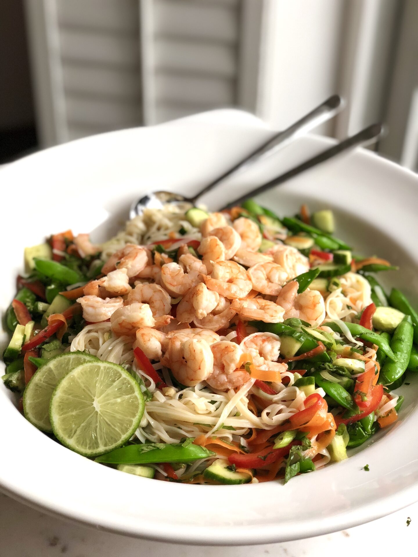 Serving bowl of Thai noodle salad with vegetables and shrimp