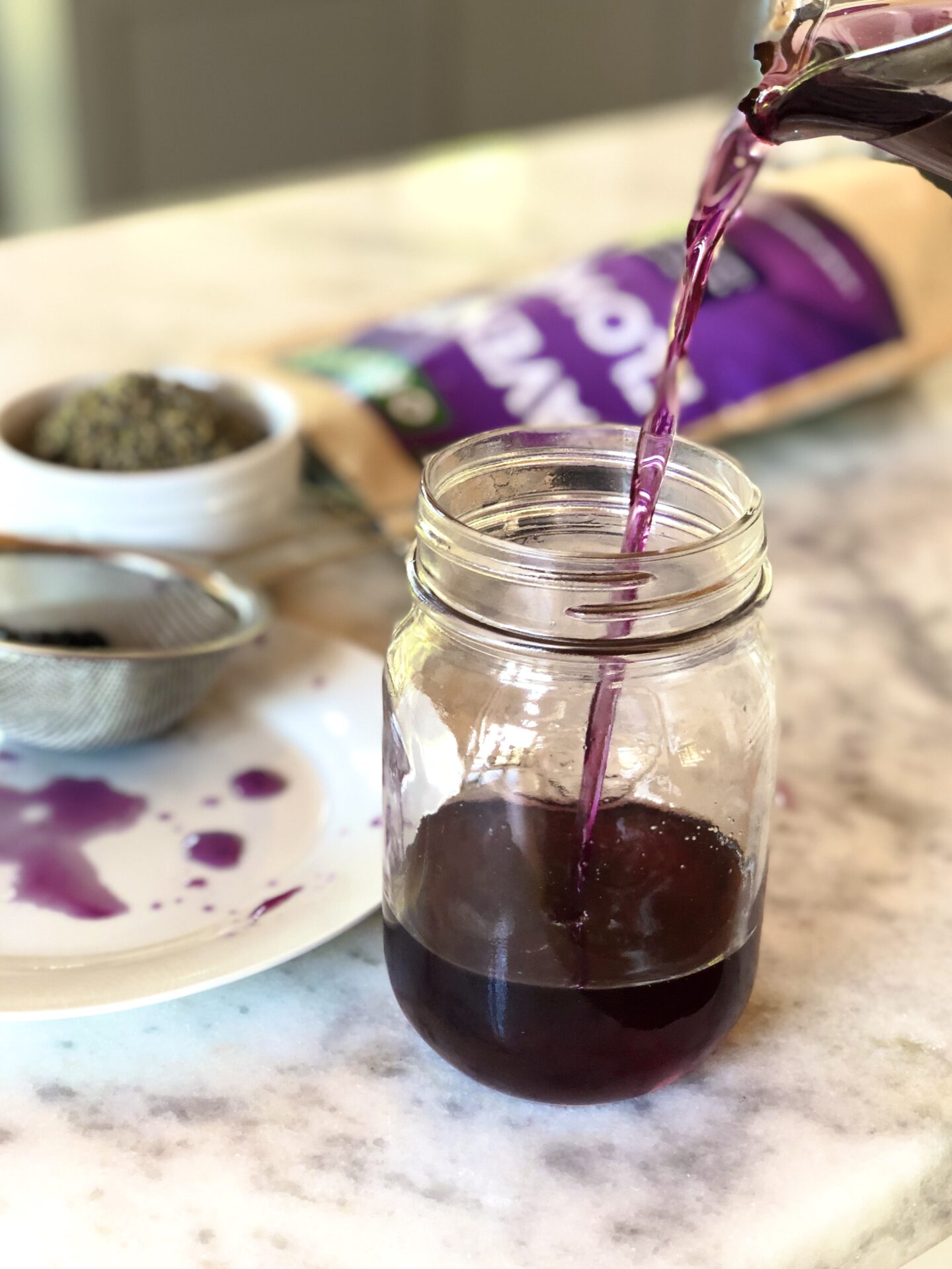Blueberry lavender syrup poured  into a mason jar