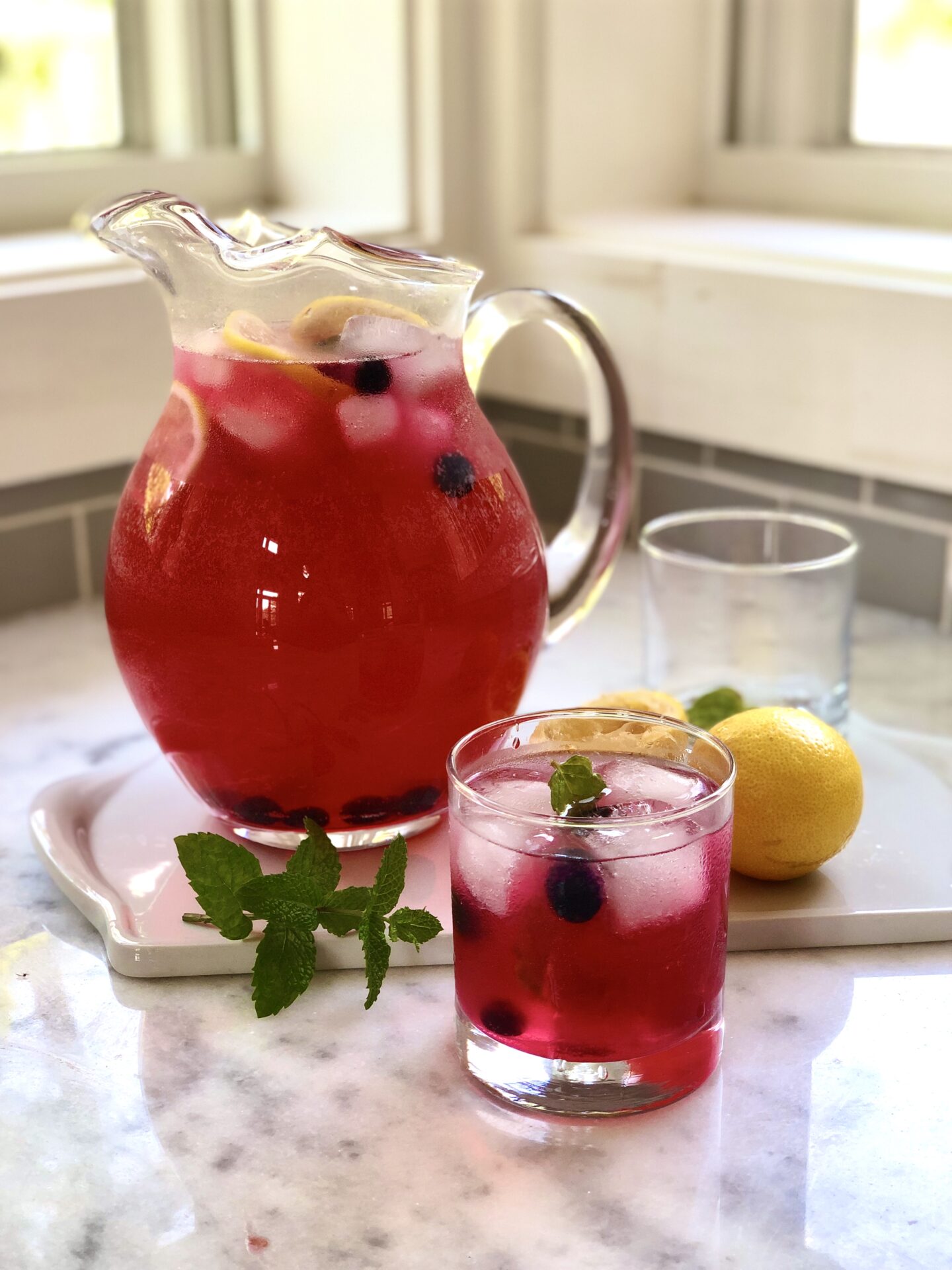 Glass pitcher of blueberry lavender lemonade