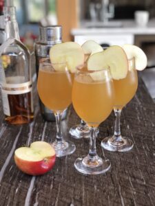 Bourbon Apple Cider Cocktails with cinnamon sugar rim and apple slice garnish