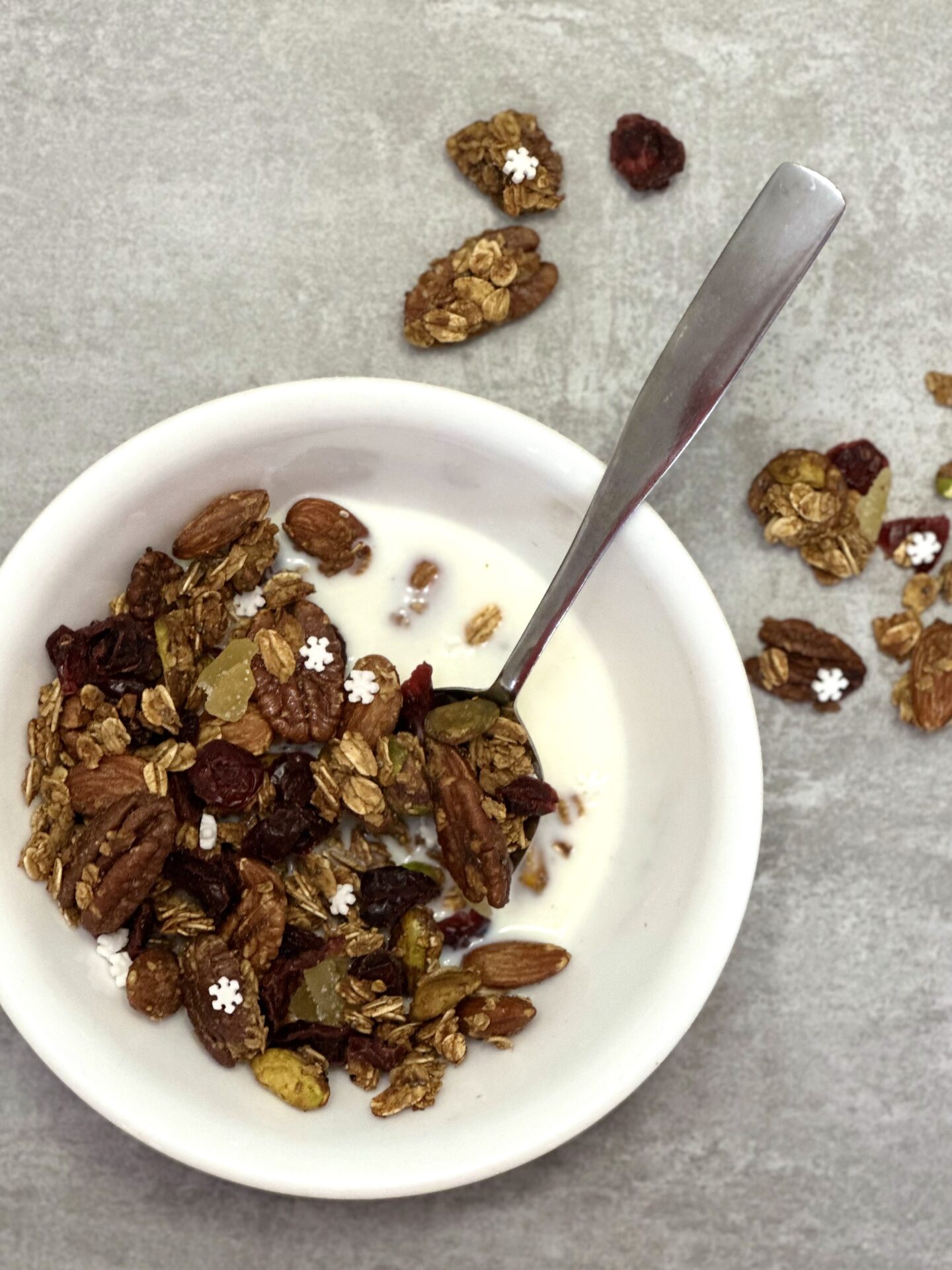 Bowl of homemade gingerbread granola served for a holiday breakfast with milk