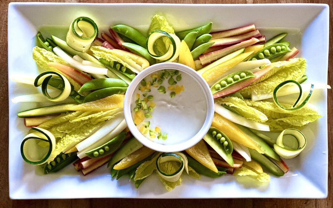 Beautiful platter of fresh spring vegetables with a creamy white dip