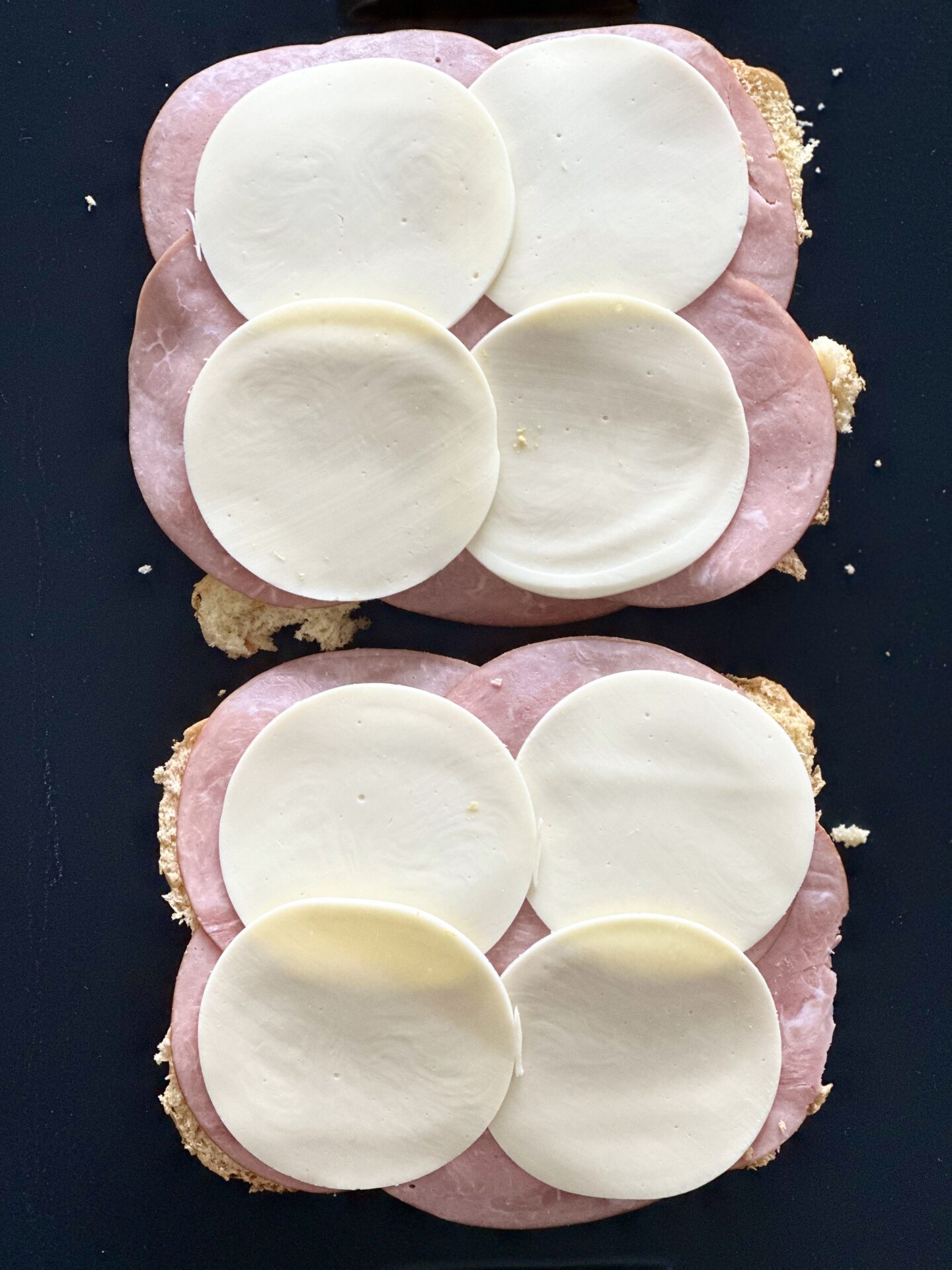Ham and Provolone cheese sandwiches being assembled