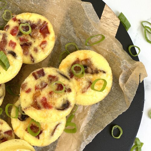 Oven baked egg bites are seen from above garnished with sliced green onions